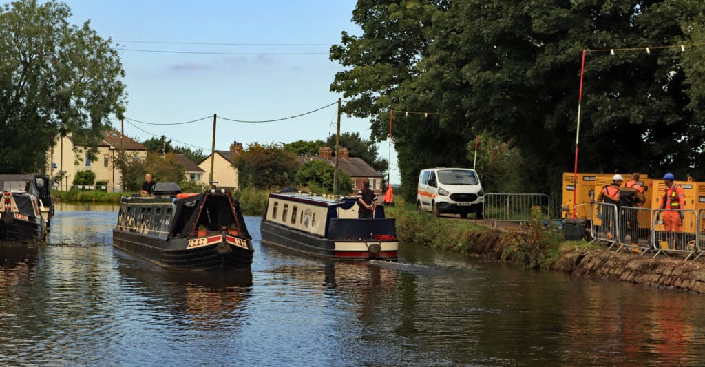 These two narrowboats, “Solstice” on the right going towards Liverpool and “Hirondelle” on the left pass each other being the first two through the repair site.