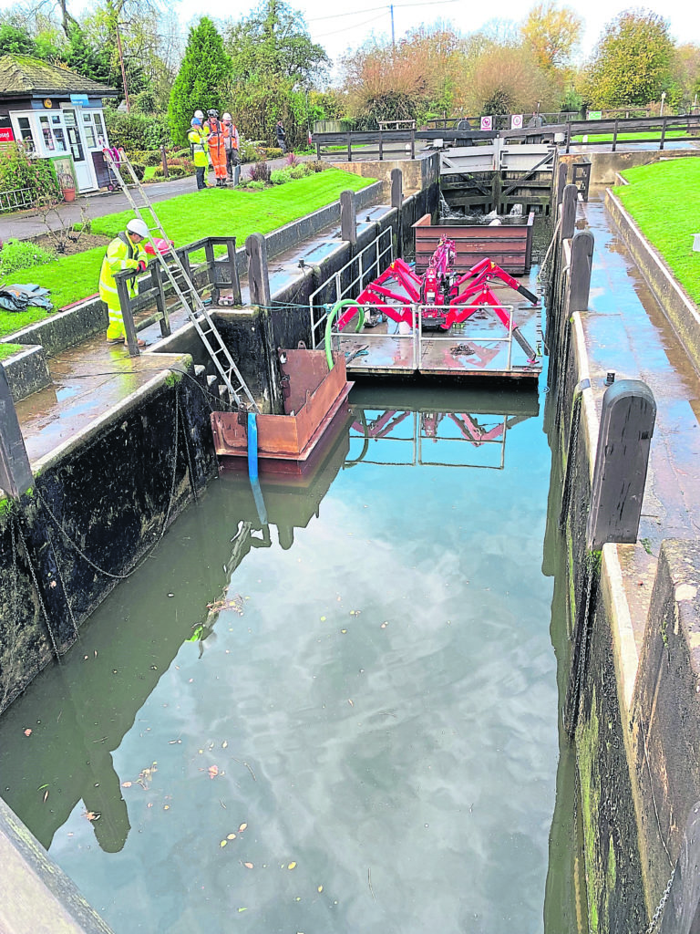 A spider crane used to lift equipment and materials on a floating pontoon at Rushey Lock.