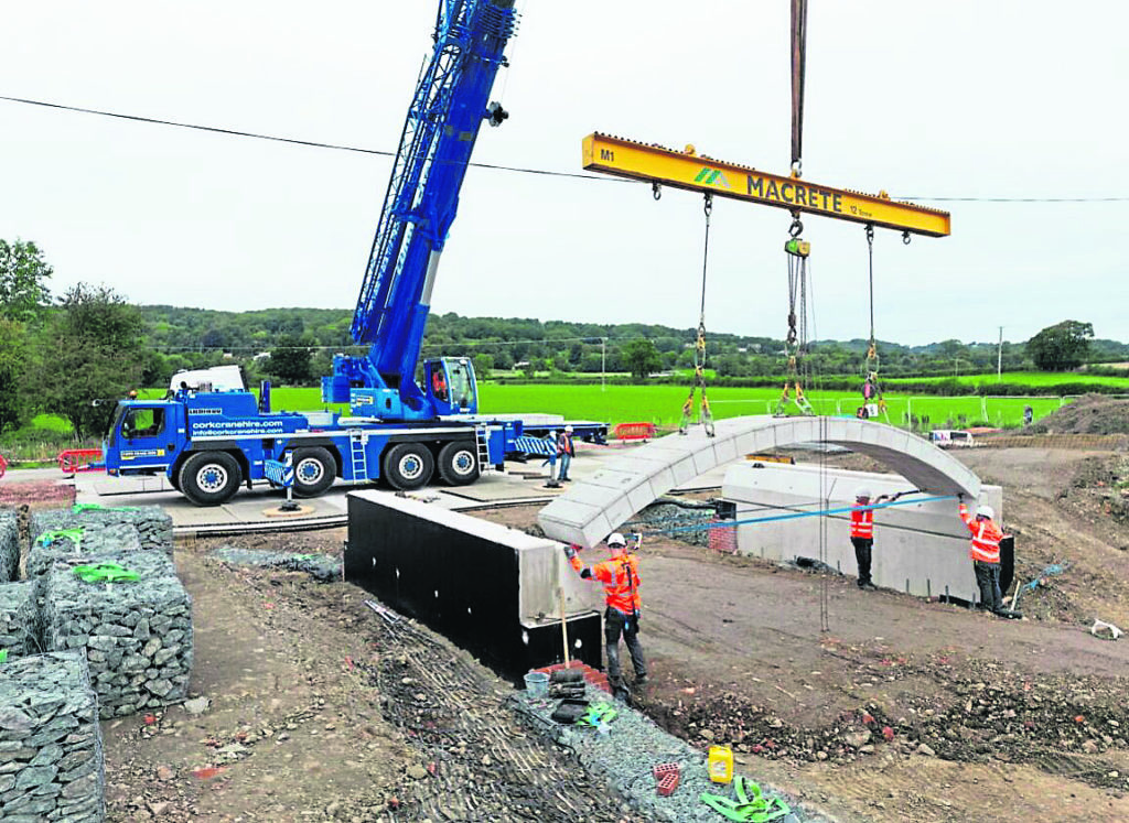 Lifting one of the six arched sections into place.