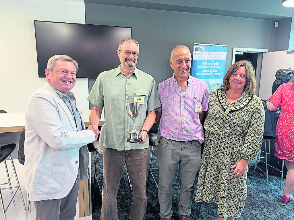 Shrewsury District & North Wales IWA branch chairman Michael Haig presents the Tetlow Cup to David Carter, chairman of the Shropshire Union Canal Society with project manager Tom Fulda and Oswestry Town Mayor, Coun Olly Rose.