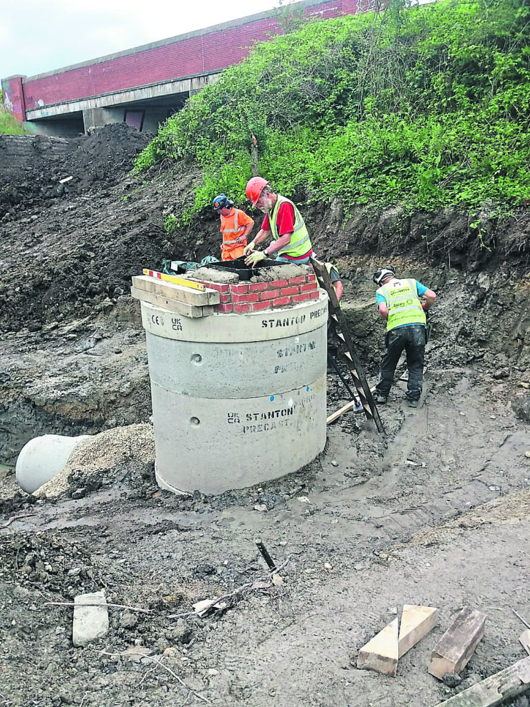 Assembling the manhole and finishing the top lid brickwork.