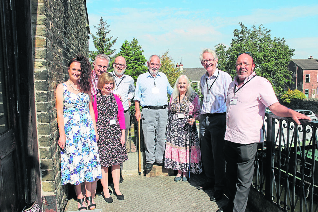 The VIPs and project team together on the balcony of the club premises. From left are: Heather Rowley,  event organiser; Catherine Baxter; Adam Baxter; Stuart Mills, Canal & River Trust; Ian Edgar, Bugsworth Basin Heritage Trust; Sarah Edgar; Rt Hon Lord Andrew Stunell and Mike Robison, project co-ordinator. PHOTOS SUPPLIED