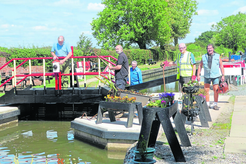 Volunteers prepare the gate for the official opening. PHOTOS: ACA