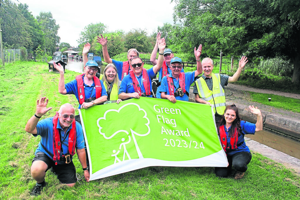 Celebrating the award of a new green flag for Cheshire’s Trent & Mersey Canal are local canal manager Paul Reynolds, centre, with trust staff and volunteers, plus volunteers from the Middlewich Clean Team. PHOTO: CRT