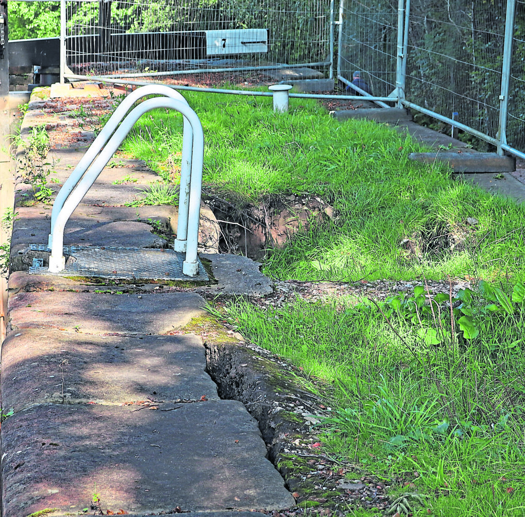 The holes behind the towpath side wall of Lock 7 on the Marple flight.