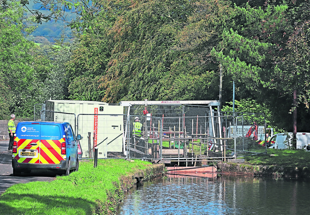 A Canal & River Trust team fitting a new head gate to Lock 9 of the Peak Forest Canal.