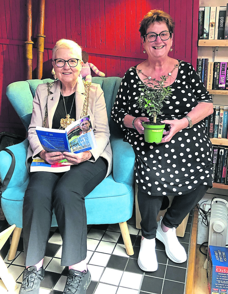 Coun Garthwaite sits down with a good book, accompanied by Alderwoman Gabriel at Hold Fast Bookshop.