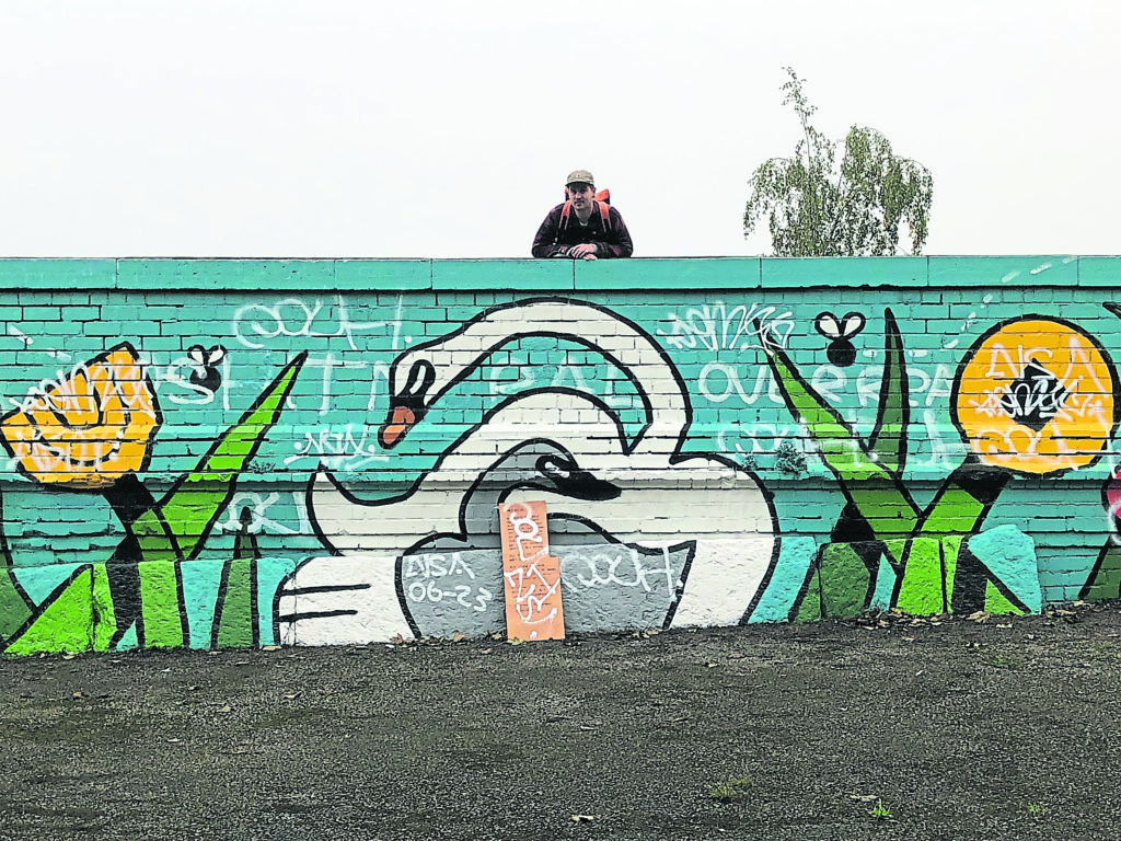 Artist Jaydon Rowbottom with the well-being mural he created which was defaced shortly after he completed it. PHOTOS: SALLY CLIFFORD unless otherwise stated