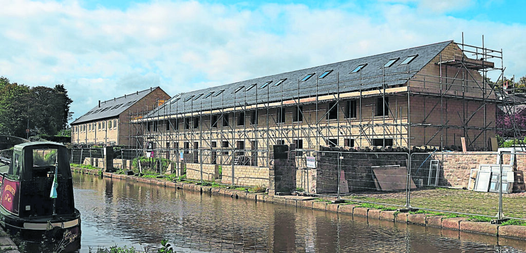 The former canal wharf at Marple being redeveloped for housing. It will be known as The Yard and will provide seven three- and four-bedroom mews cottages.
