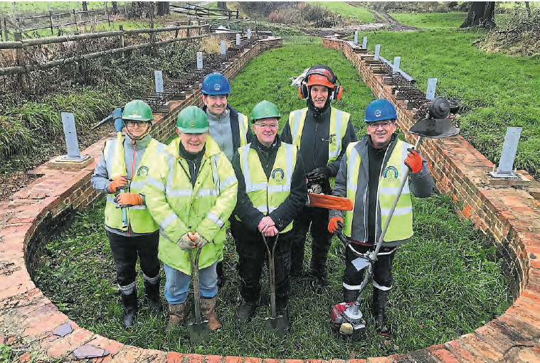 Branch chairman Dave Maloney, third from right, with work party volunteers in the dry dock being restored at Pewsham Locks. PHOTO: JUSTIN GUY