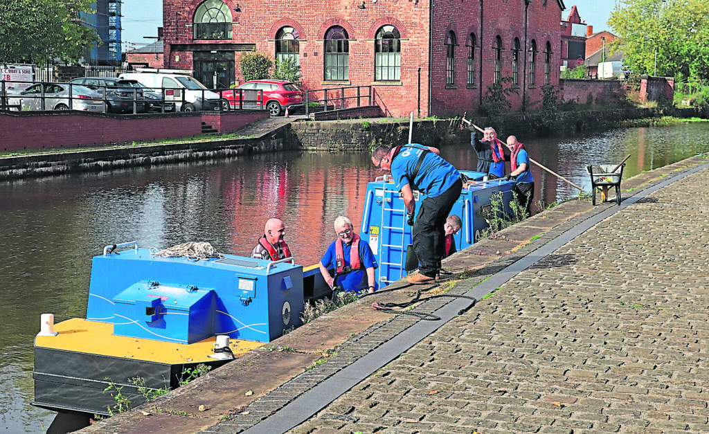 Canal & River Trust volunteers working from workboat Mersey at Wigan.PHOTO: COLIN WAREING