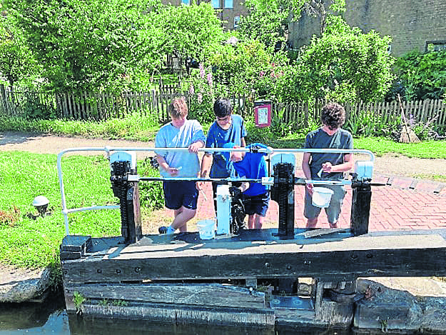 Painting the railings over the lock gates. PHOTOS: PAUL GREENHALGH