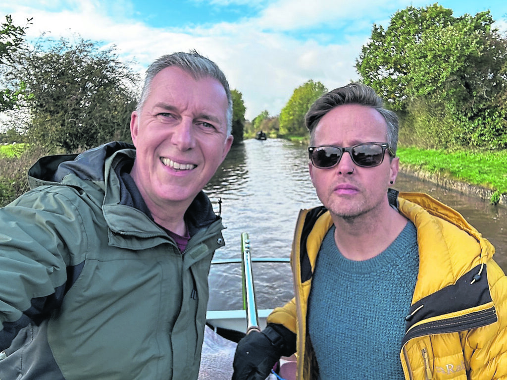 Paul and Anthony aboard their current craft, a serial hybrid electric boat built by Oakums. PHOTO: SUPPLIED