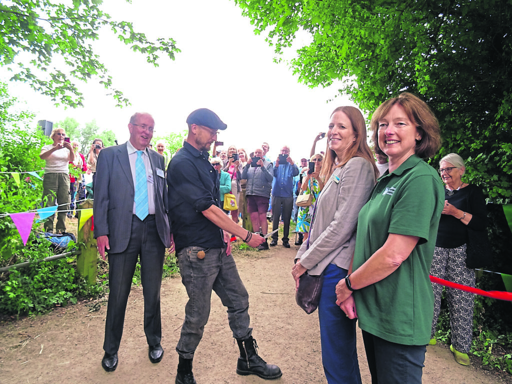 TV personality Robbie Cumming cuts the ribbon with (left) WCT chairman Clive Johnson and (right) Ros Daniels, of the Canal & River Trust, and Dr Elaine King, of Chiltern National Landscape.