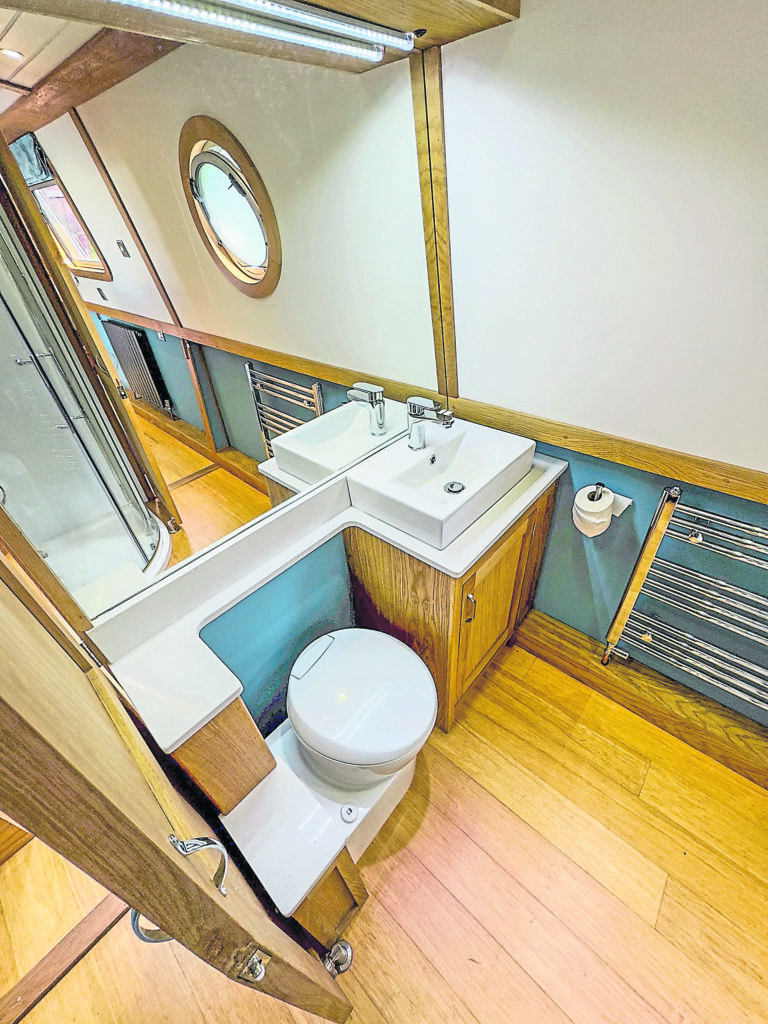 A huge mirror in the bathroom makes the room look even bigger.