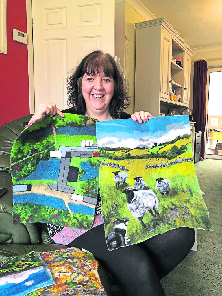 Fabulous felt: Janine Jacques with her feltworks, featuring the aerial view of Leeds Industrial Museum and the Leeds & Liverpool canal, along with her woolly friends from childhood. PHOTO: SALLY CLIFFORD