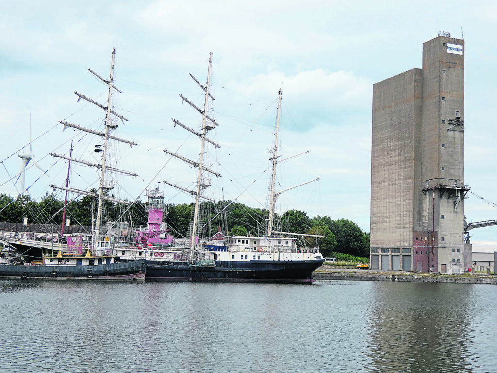 Sail Training Vessel Tenacious, with an old light vessel in the background.