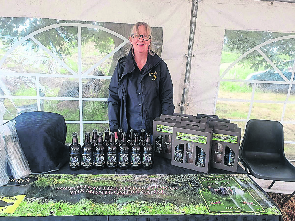 Pamela Honeyman, from Monty’s Brewery, attended a ceremony in June to mark the restoration of Schoolhouse Bridge on the Montgomery Canal. PHOTO: SUCS