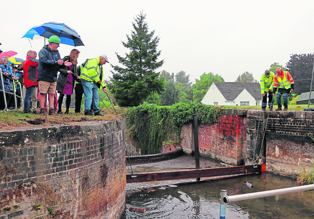 Stop planks are lowered into Dock Lock pound, which is being restored as part of Cotswold Canals Connected. The event was held to raise the profile of the Fromebridge Biodiversity Project. PHOTO: Stroud District Council