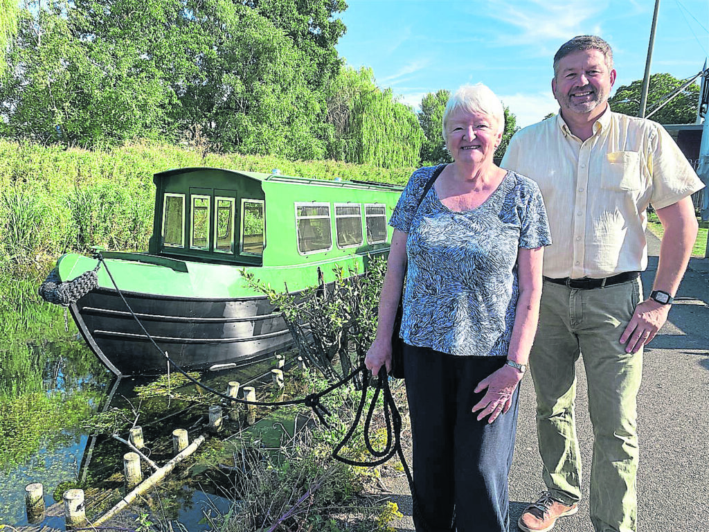 The Benjamin Handley sitting in the River Slea with chairman of Sleaford Navigation Trust Chris Hayes and North Kesteven District Council leader Coun Richard Wright. The boat will take visitors on the river from next spring as part of a historic trip from The Hub in Sleaford and Cogglesford Watermill.