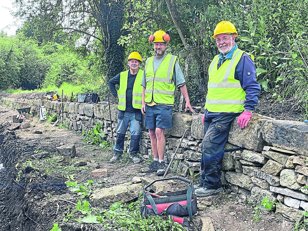 Volunteers pictured with the restored Tramway Wharf Wall at Crickheath.