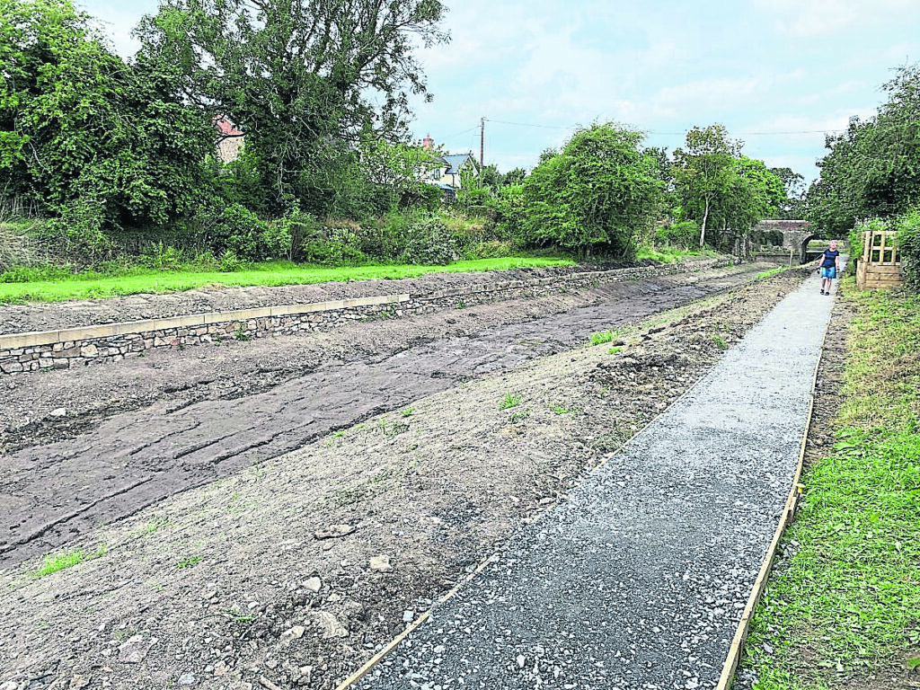 The Crickheath Wharf area before volunteers tackled it. The latest phase in the Montgomery Canal restoration project has been completed with the new wall, towpath and clearance work.