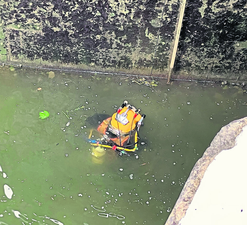 A specialist diver goes under the waterline at Weston Lock. PHOTO: CRT