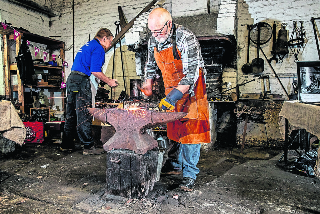 David Wadsworth and fellow volunteer Phil ‘bellow boy’ Bristow demonstrate the ancient art of blacksmithing at Dobson Staircase Locks at Apperley Bridge on the Leeds & Liverpool Canal as part of a Heritage Open Days event run by the Canal & River Trust. PHOTO: SUPPLIED