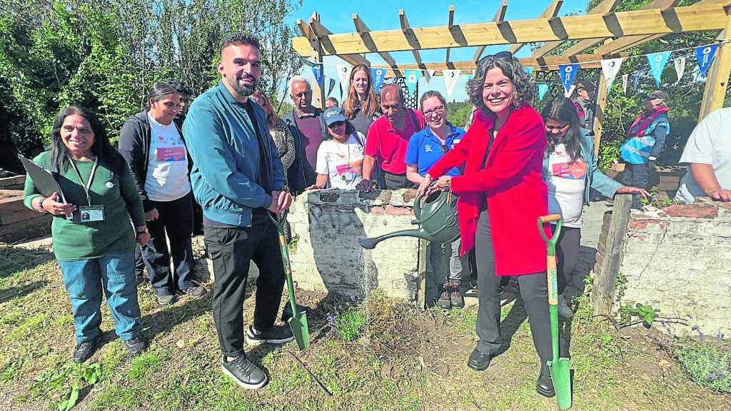 Ready to dig and water in: Deputy Mayor for Environment and Energy Mete Coban joins Deirdre Costigan, MP for Ealing Southall, and members of the Southall community to plant the lockside community garden and launch new wetland in Glade Lane Canalside Park. PHOTO: SUPPLIED