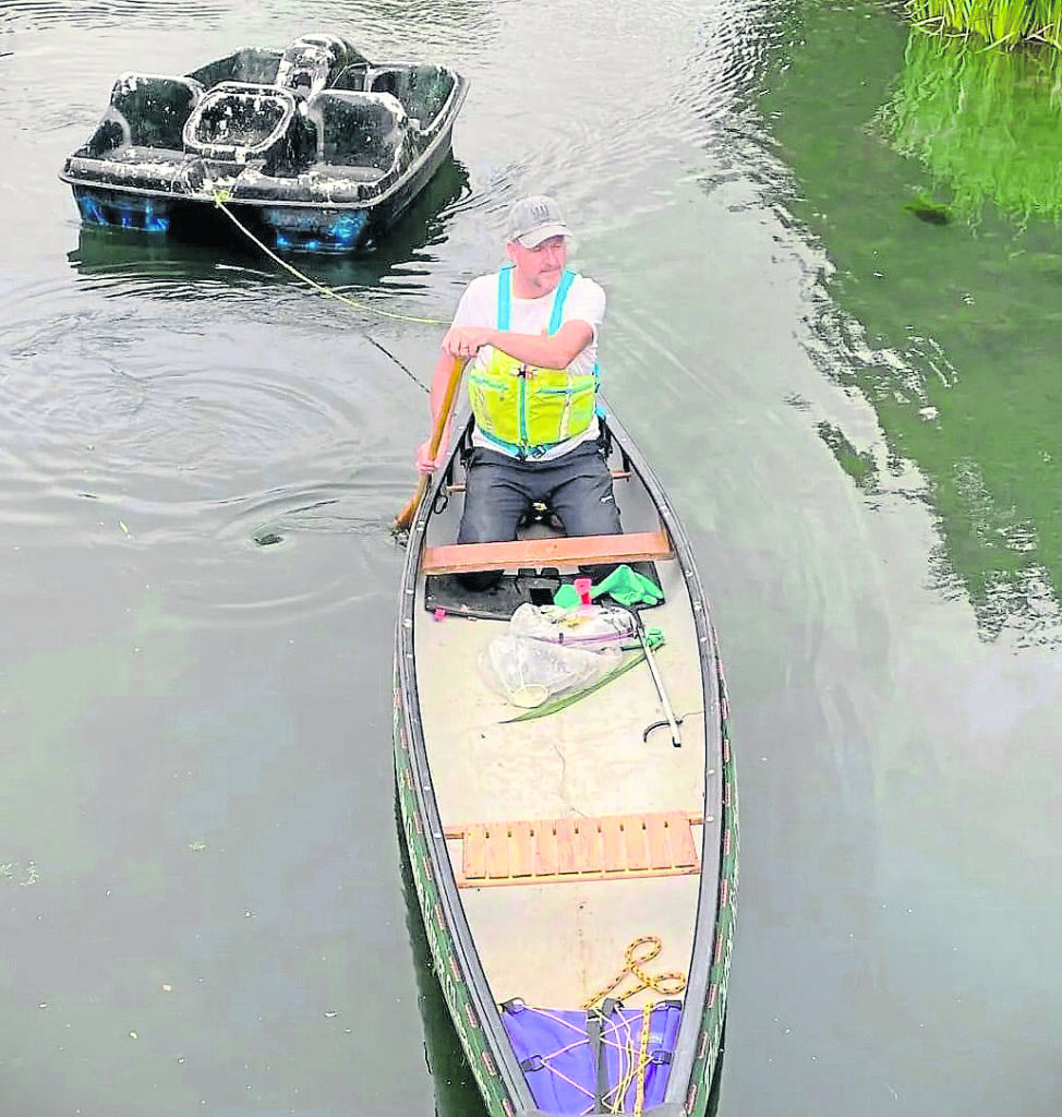 Jim towing an abandoned pedalo.