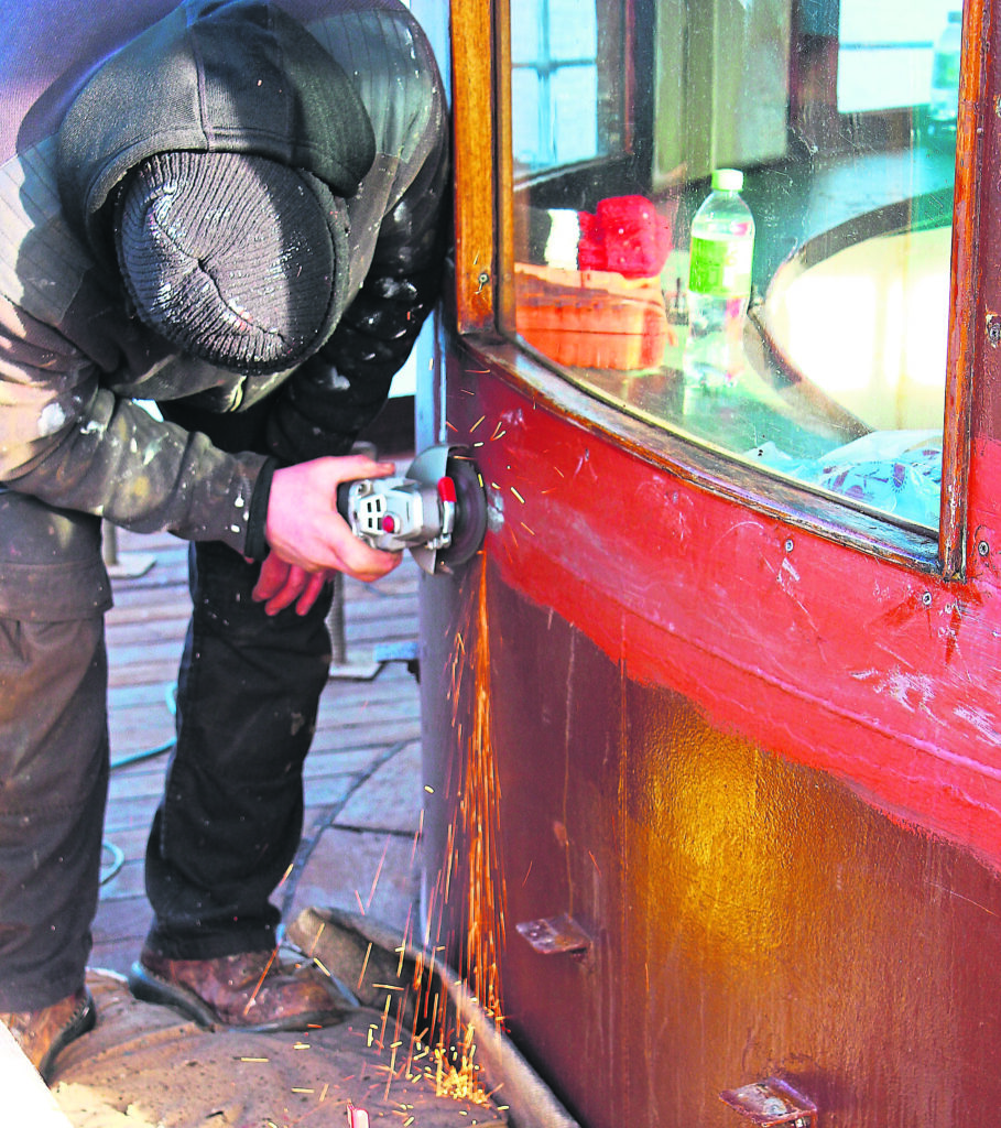 Sparks fly as work goes on to kill rust on the passenger shelter. PHOTO: HUGH DOUGHERTY
