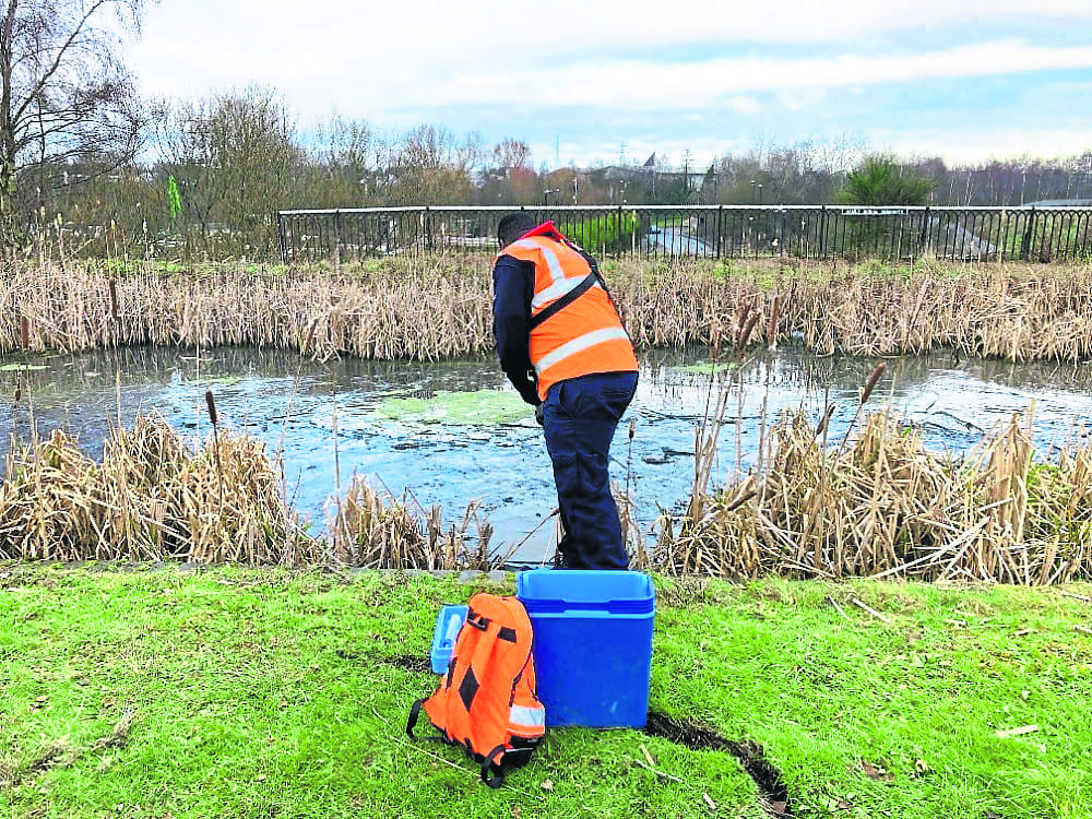 An engineer tests the water from the Walsall Canal as recovery efforts continue on the waterway. PHOTO: SUPPLIED