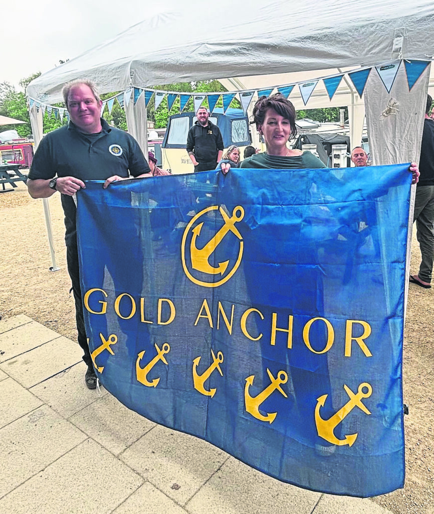 Manager Mellissa Williams and assistant manager Mike Garforth holding the flag. PHOTO: SUPPLIED