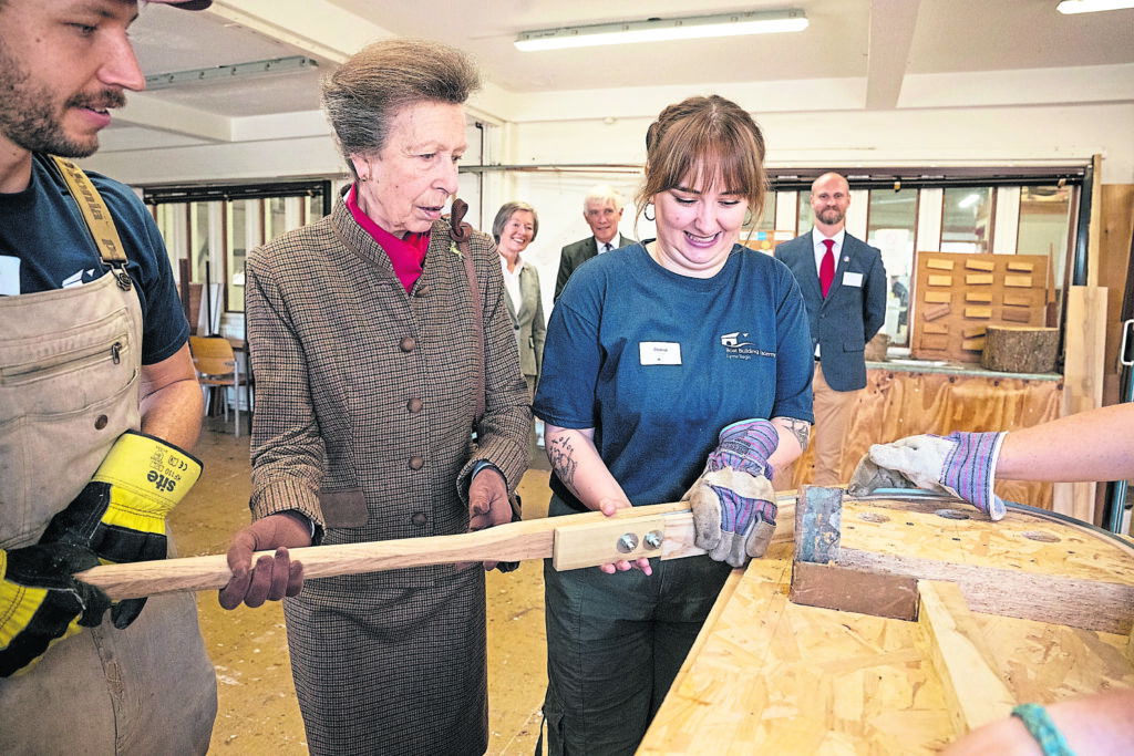The Princess Royal assists students of the Boat Building Academy during a demonstration of steam bending. ALL PHOTOS: PHILIPPA GEDGE PHOTOGRAPHY