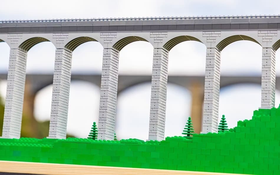 The model of the aqueduct with the real structure behind it