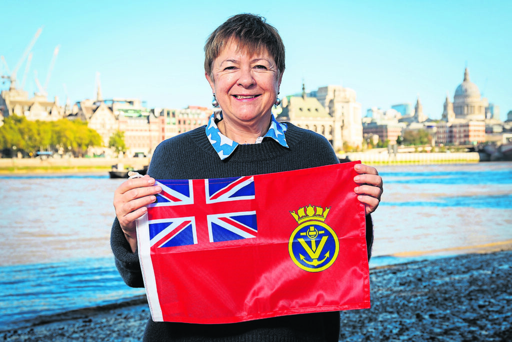 Susan proudly displays the MVS flag. PHOTO: MARITME VOLUNTEER SERVICE