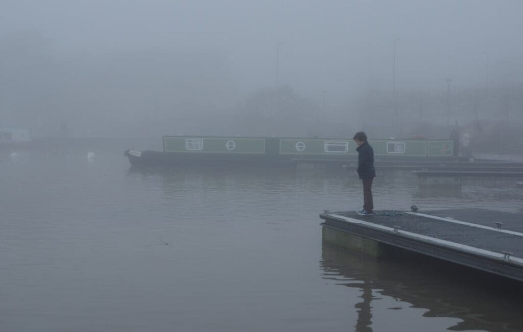 A boy surveys the water on a foggy day at Bancroft Basin, at the southern end of the Stratford Canal. STEPHEN MCKAY – CC BY-SA 2.0